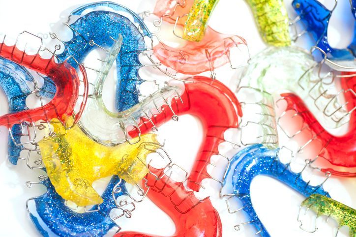 Colorful translucent plastic links tangled in a bright abstract pattern on a white background