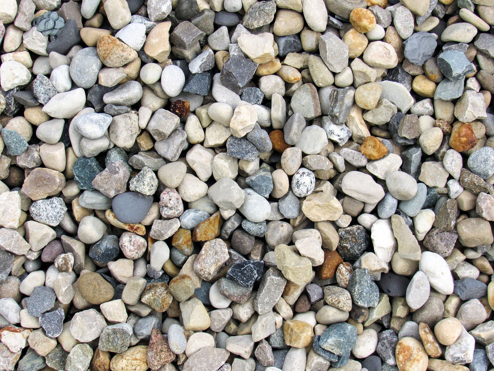 Close-up of crushed grey stone aggregate, perfect for gravel delivery and driveway projects. Close-up of crushed grey stone aggregate, perfect for gravel delivery and driveway projects.