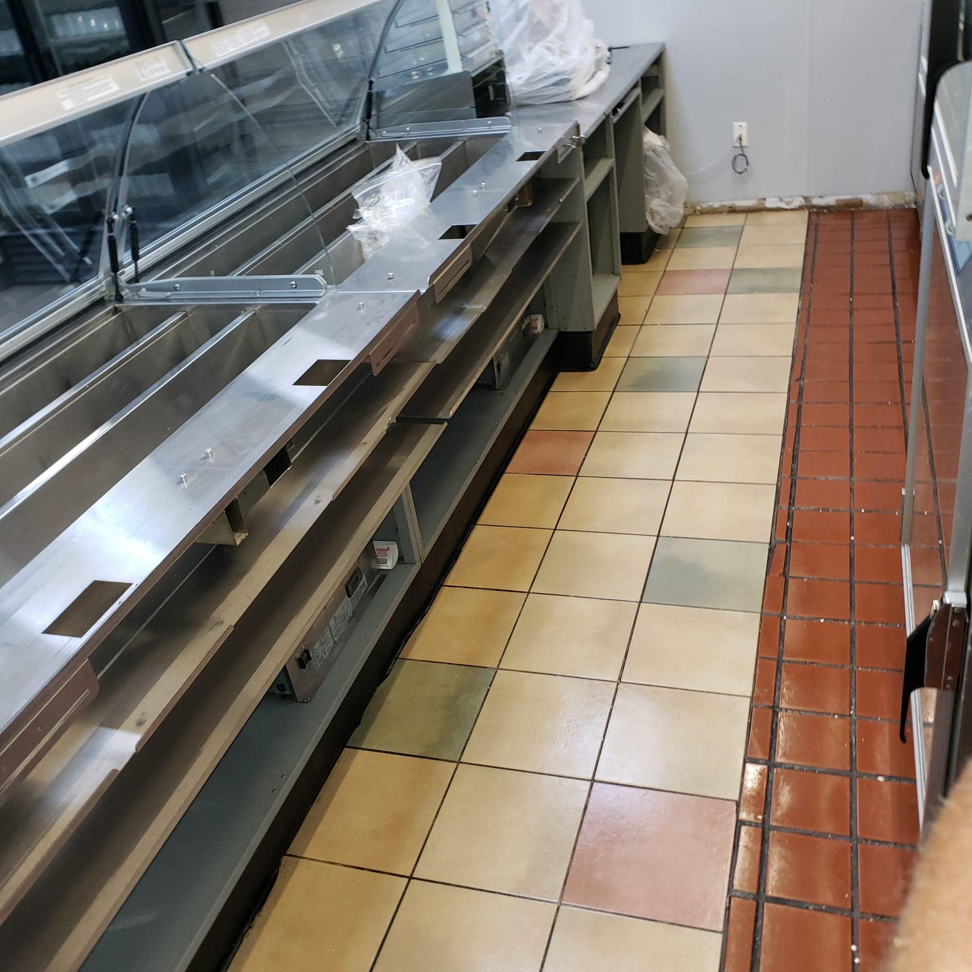 A row of stainless steel counters in a kitchen