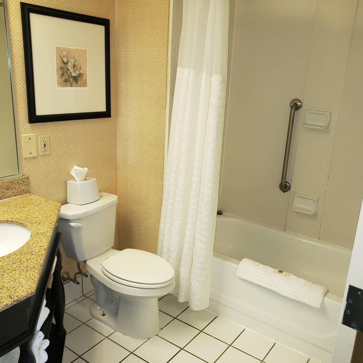 A bathroom with a toilet a sink and a bathtub