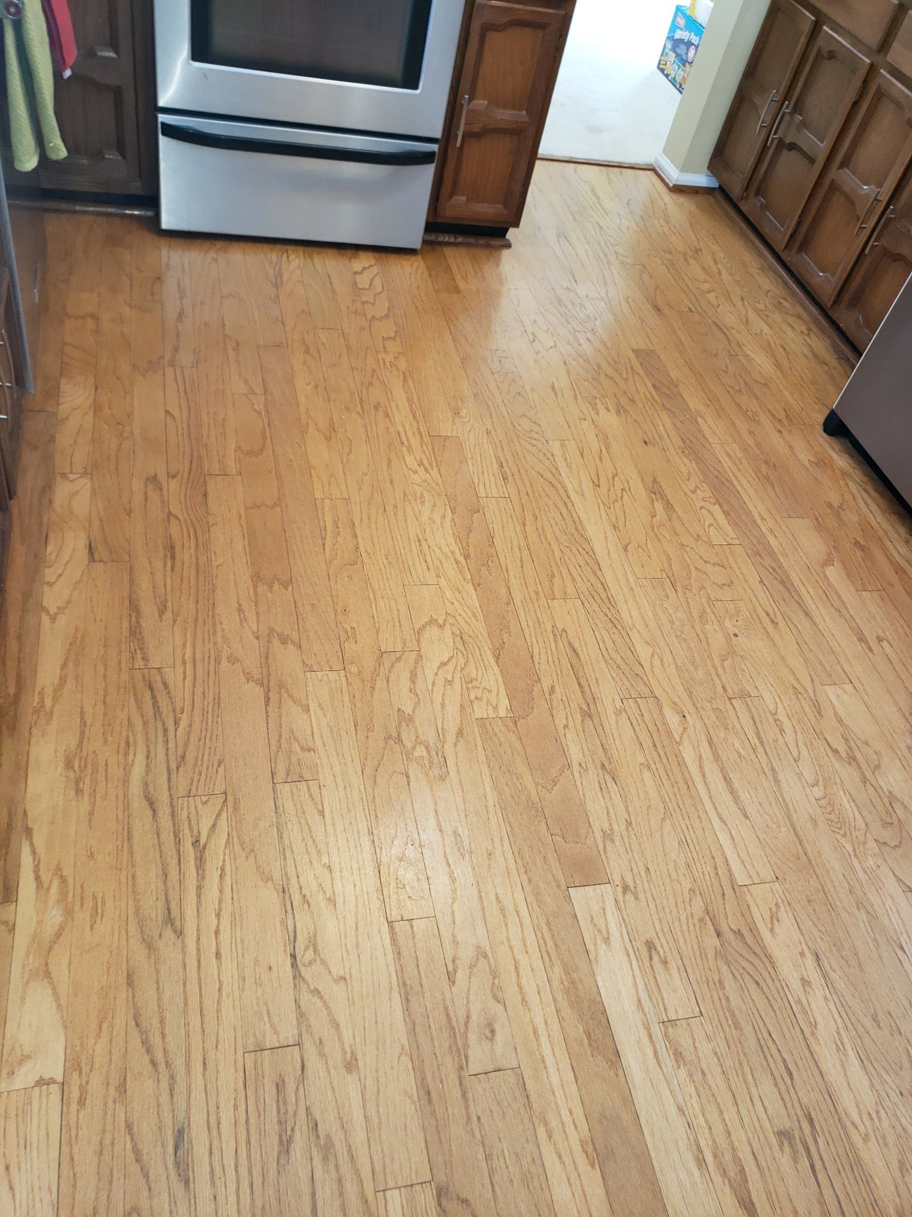 A kitchen with hardwood floors and a stove.