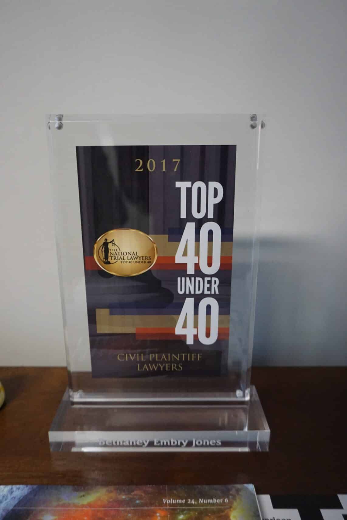 2017 “Top 40 Under 40” award plaque displayed on a clear stand