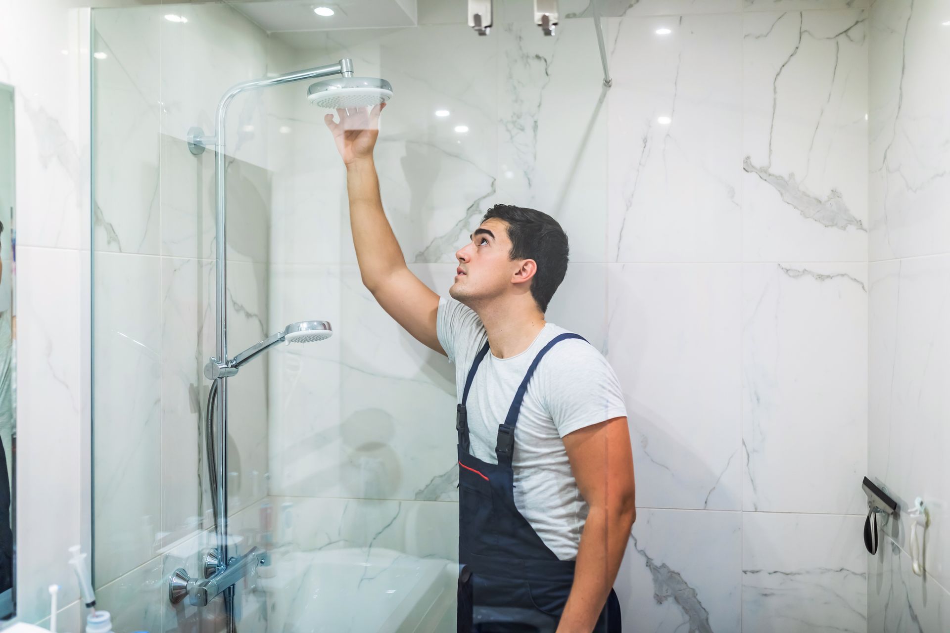 Plumber fixing shower

