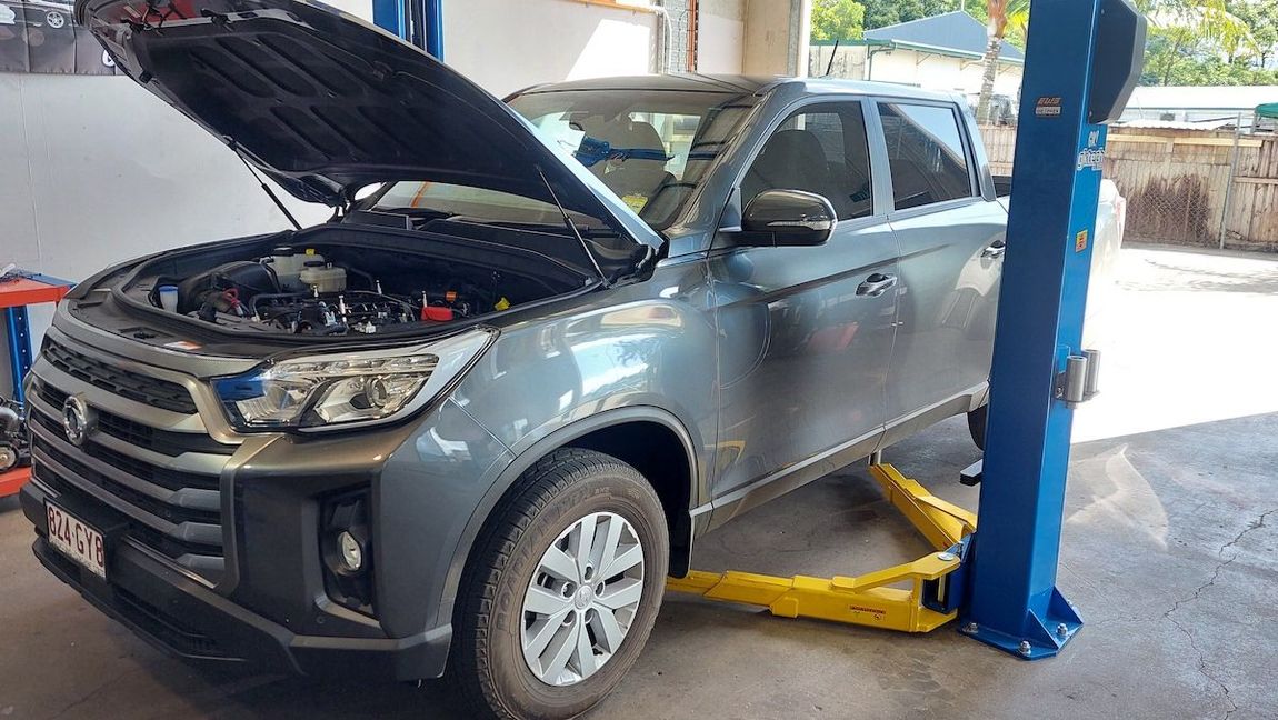 A Truck with The Hood up Is on A Lift in A Garage — Wilkomotive Mechanical in Bentley Park, QLD