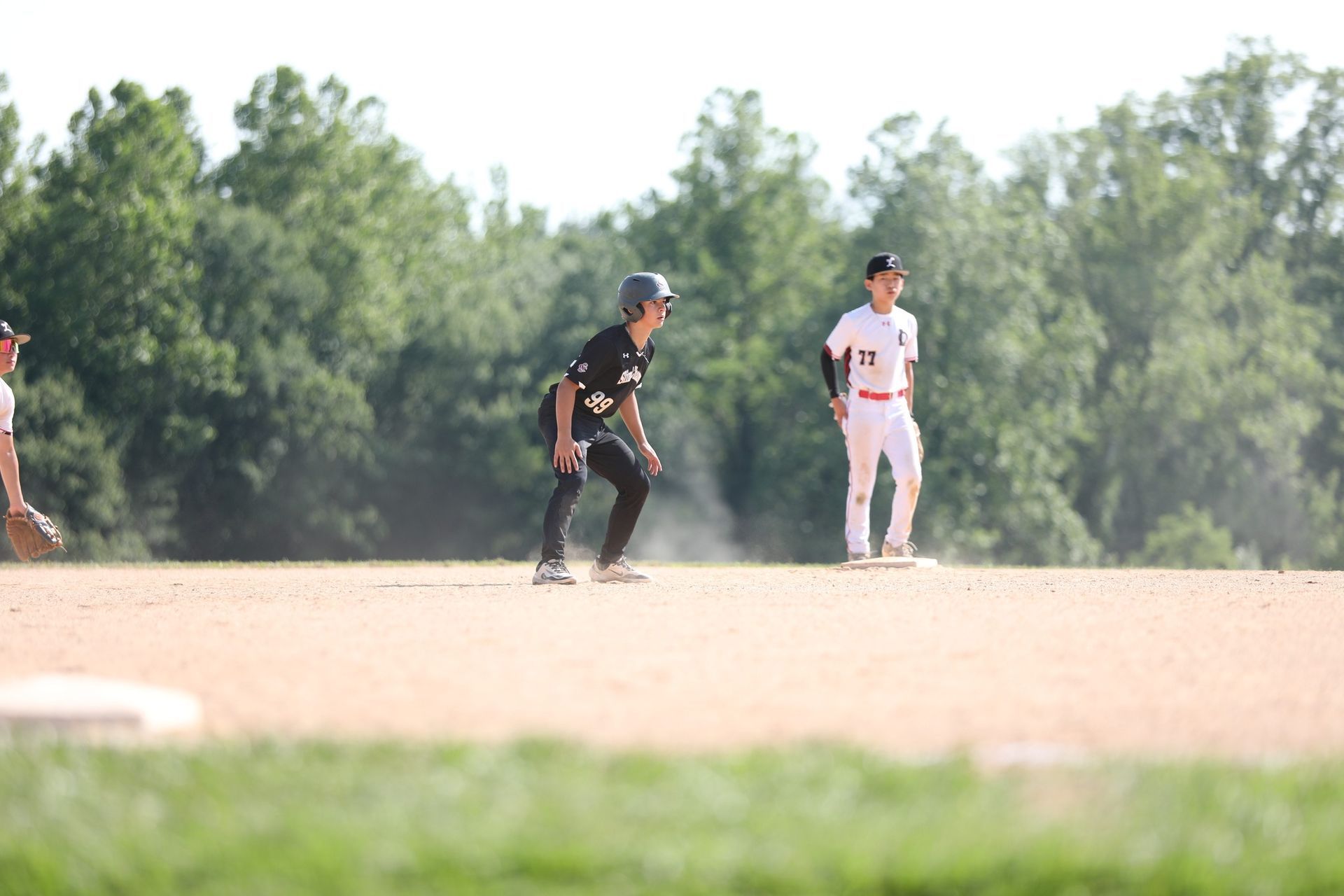 Youth baseball player leading off second base