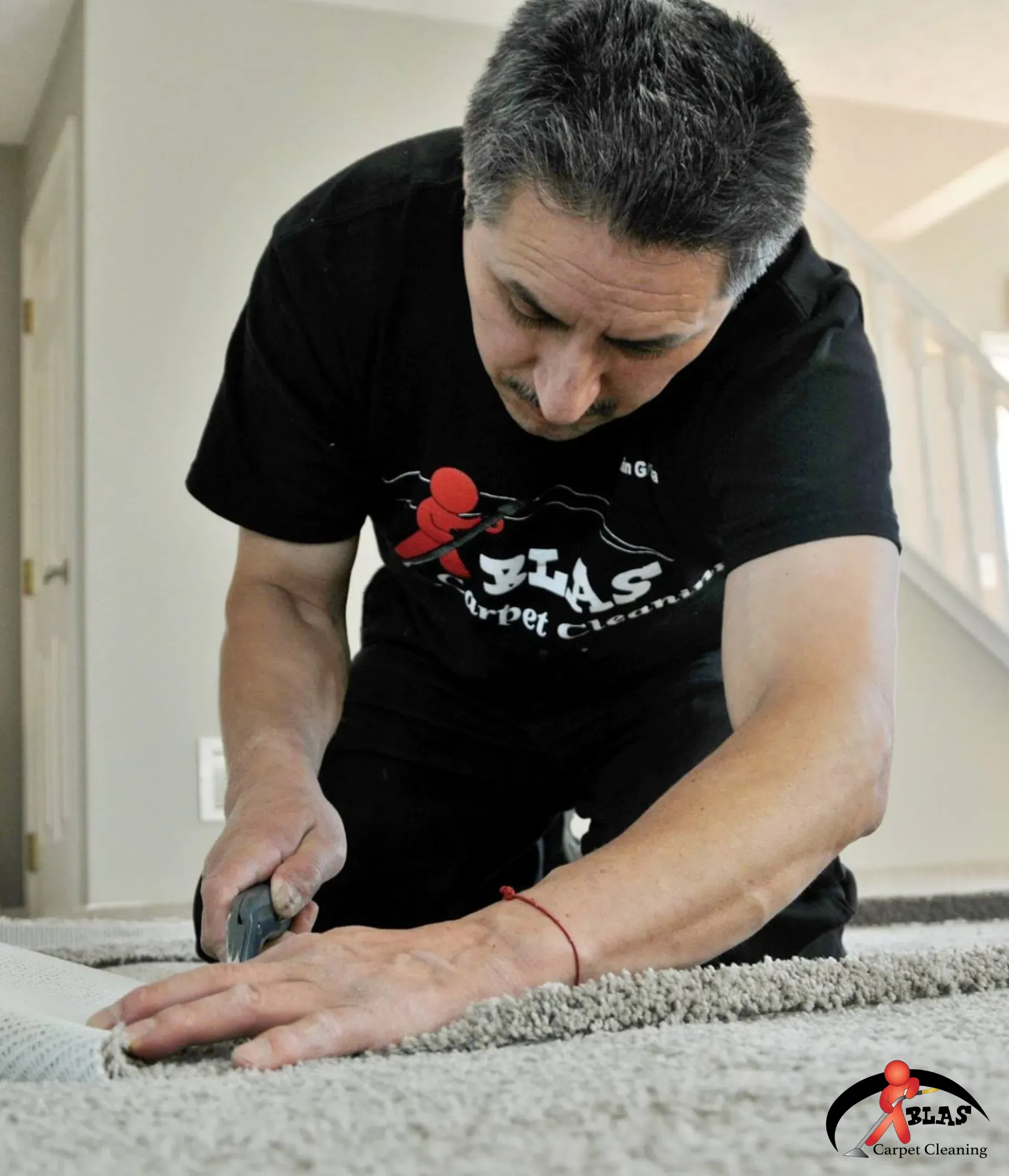 Blas Carpet specialist installing new carpet in Atlanta Georgia home.