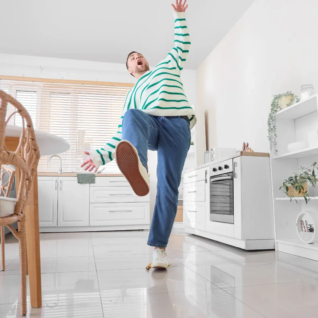 Guy falling due to wet floor without anti slip tile coating.