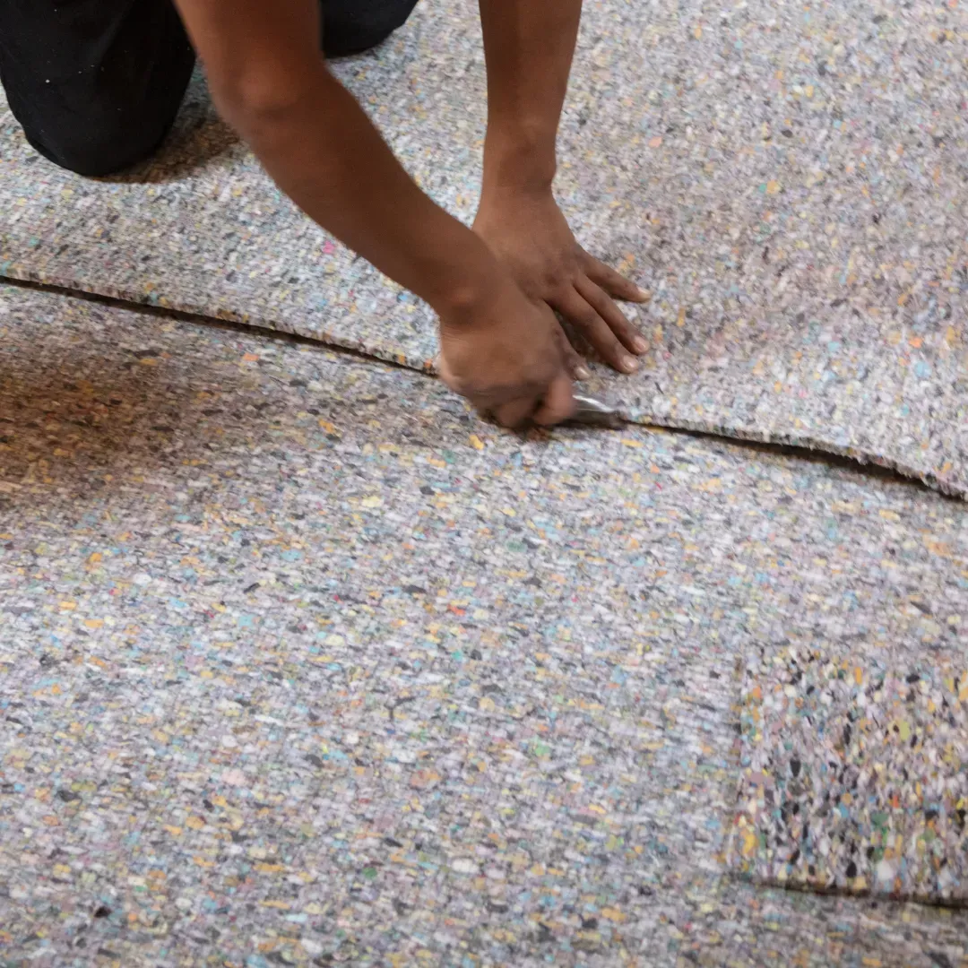 Blas Carpet specialist installing new carpet padding down in Denver, Colorado home.