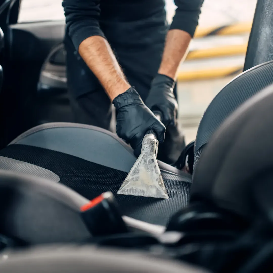 Blas Carpet specialist eliminating stains on car seats using the upholstery steam cleaning method in Columbus, Ohio