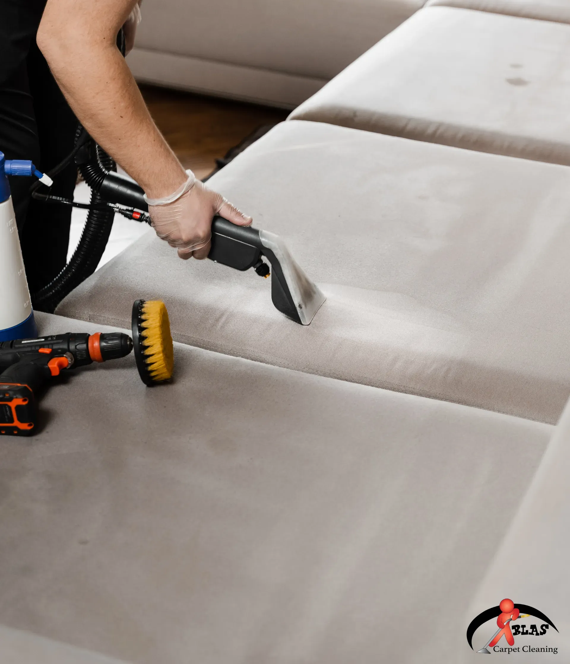 Professional upholstery cleaning specialist removing stains from sofa in Atlanta, Georgia home.