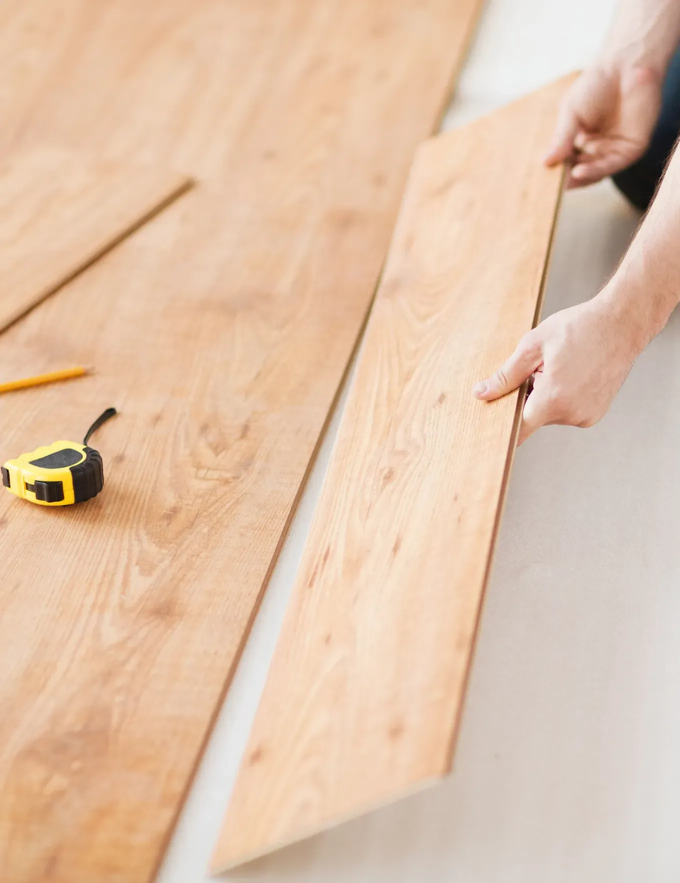 Hardwood flooring getting installed by experts at Blas Carpet in Denver, Colorado.