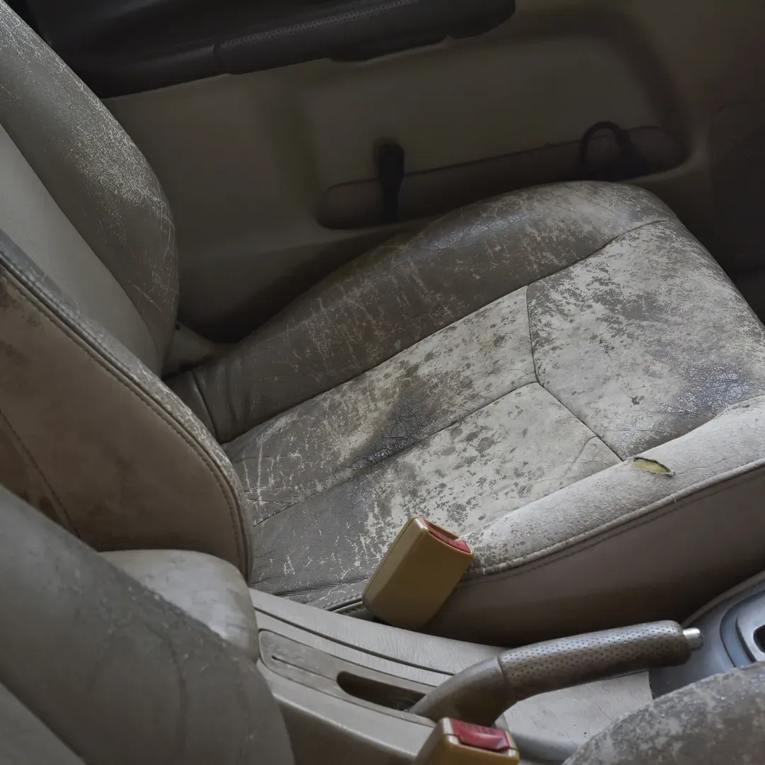 Stains on auto interior carpet and seats getting ready to be professionally steam cleaned in Denver, Colorado.