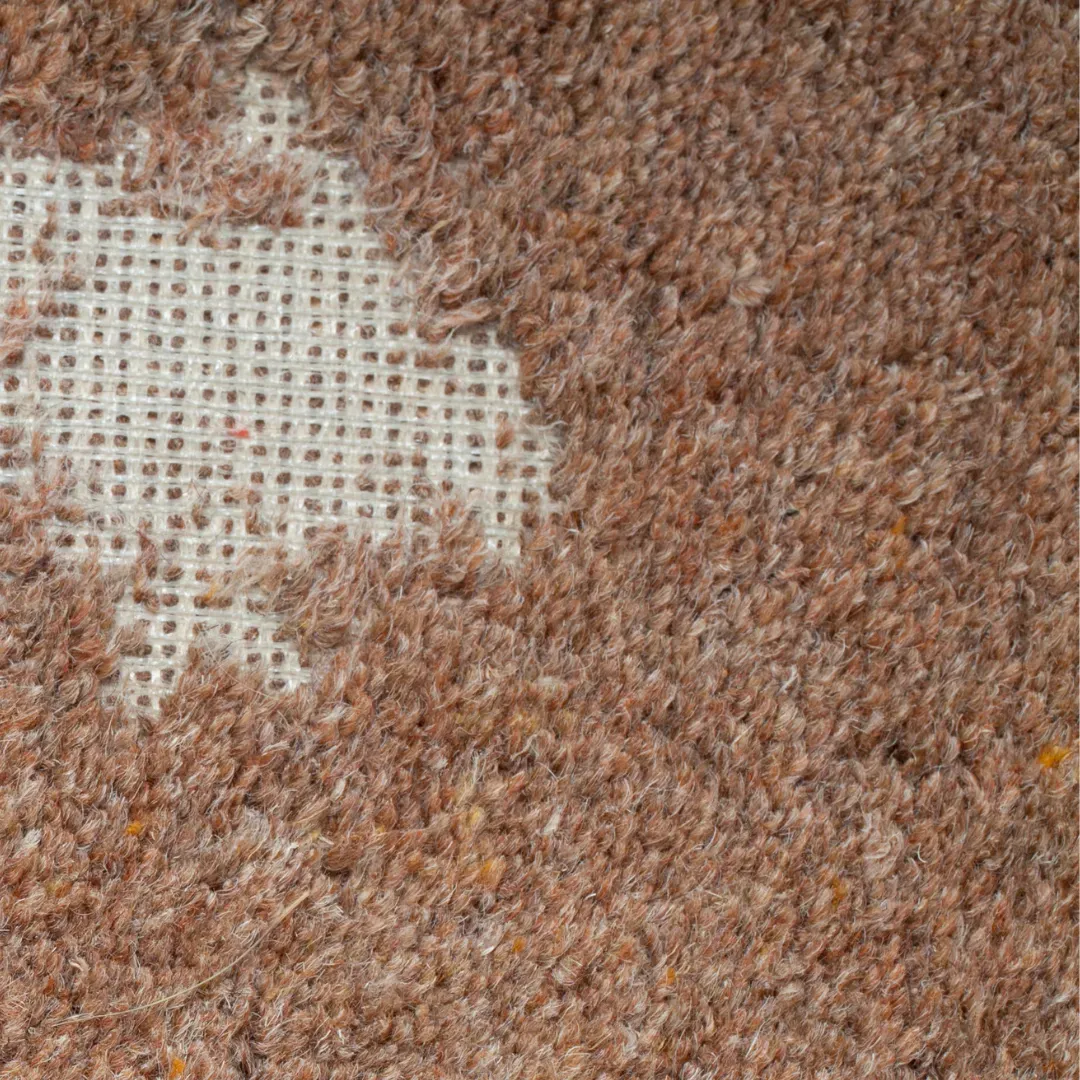 Damaged bedroom carpet getting restored using carpet repair methods in Atlanta home.