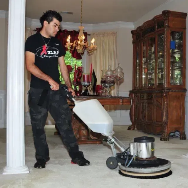 Professional Blas Carpet technician shampooing living room carpet in Atlanta, Georgia home.