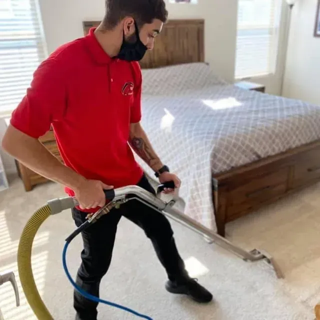 Blas Carpet employee is steam carpet cleaning bedroom carpeting in Denver, Colorado