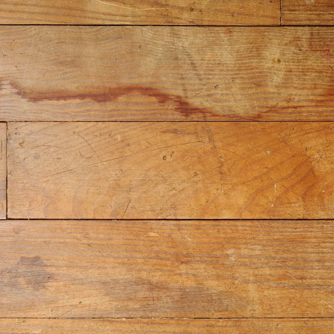 Hardwood floor with warping and gapping before resurfacing service.