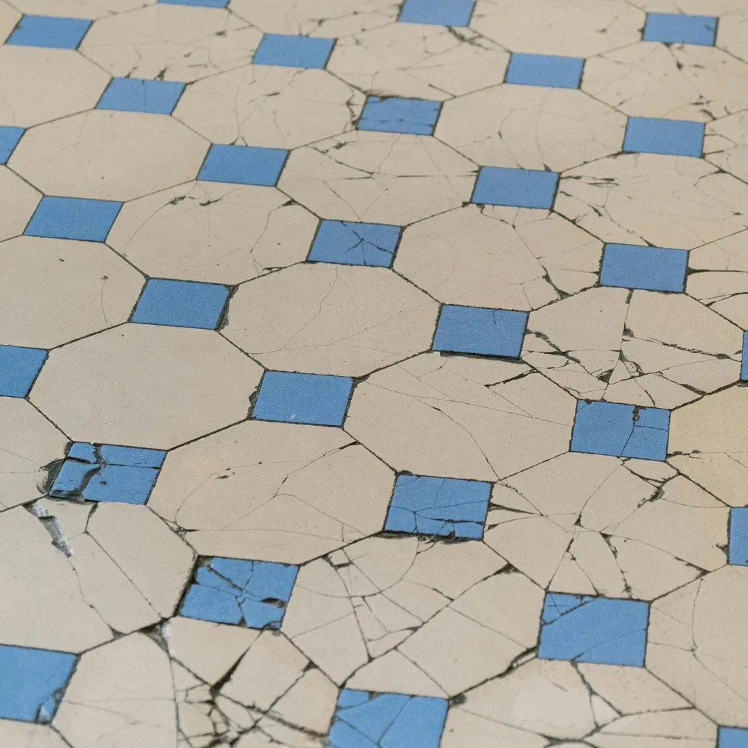 Damaged ceramic tile flooring being repaired.