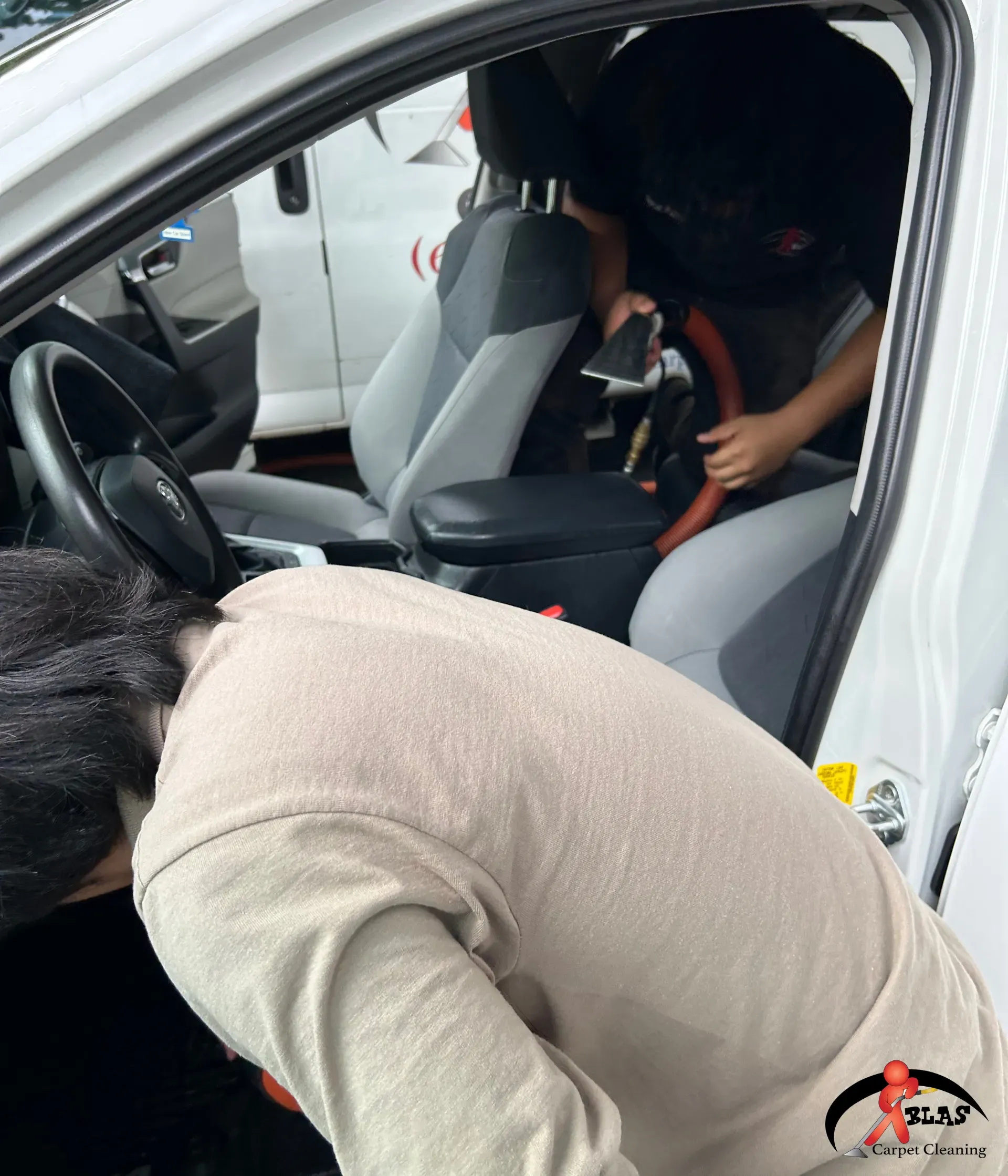 Professional car interior detailing specialist removing stains in Atlanta, Georgia.