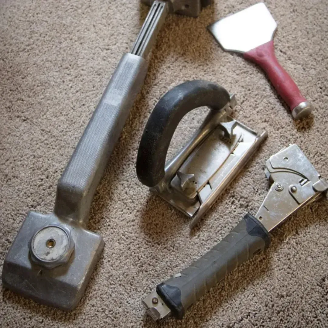 Blas Carpet specialist fixing damaged carpet in Atlanta home.