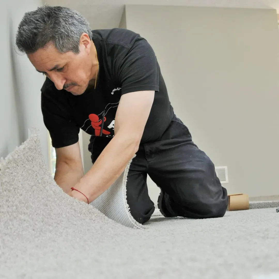 Blas Carpet specialist installing new carpet.