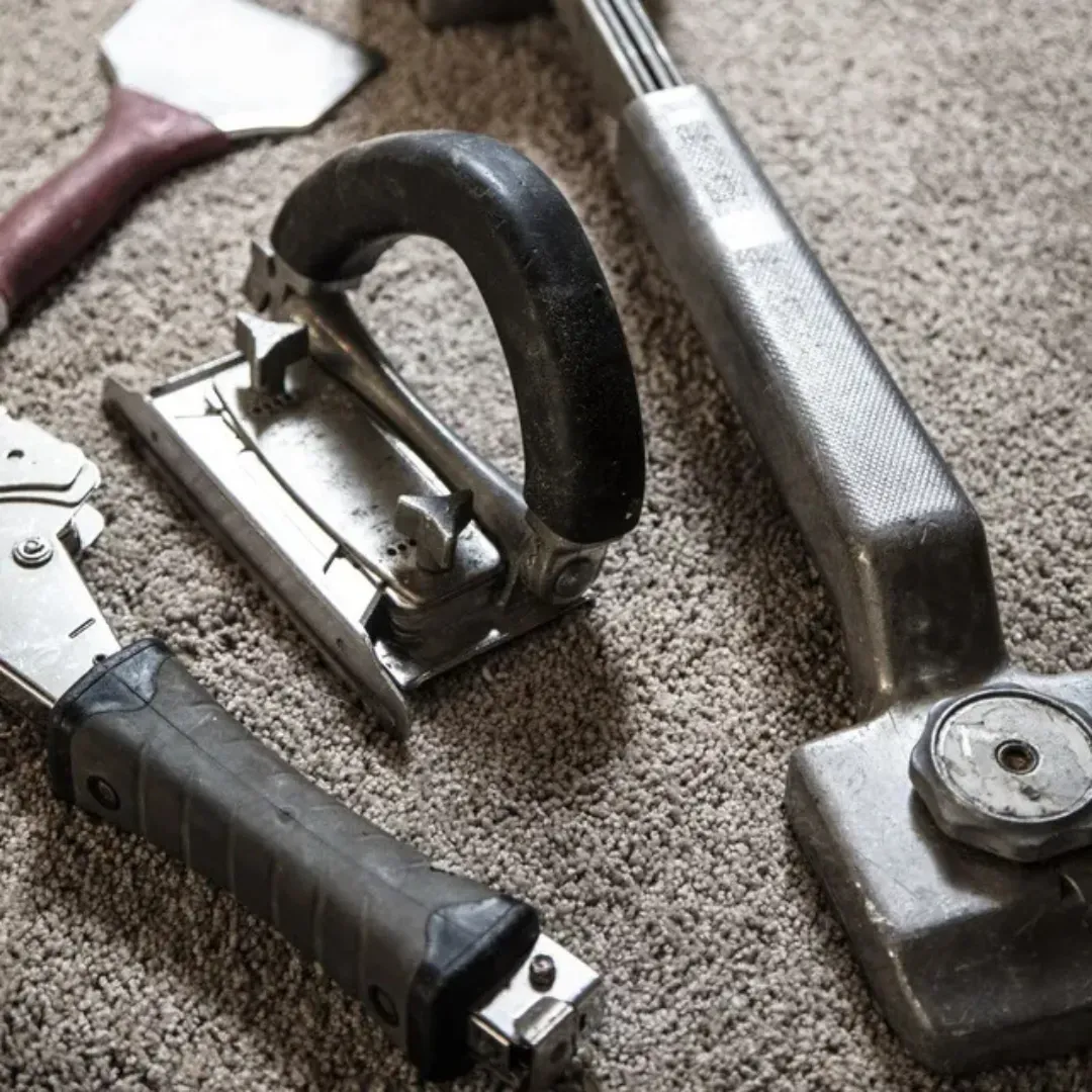Blas Carpet specialist fixing damaged carpet in Atlanta home.