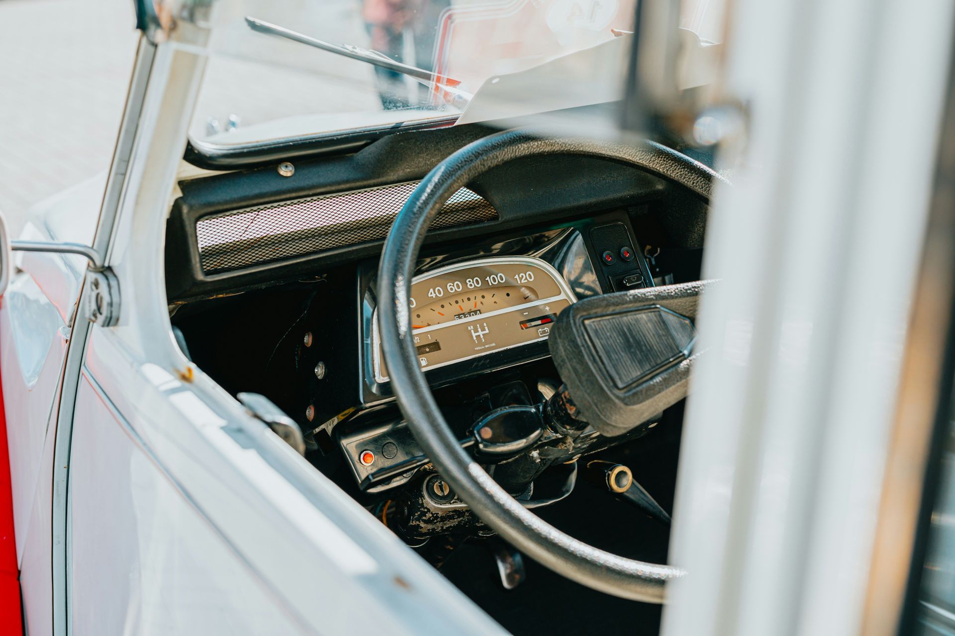 A close up of a car dashboard with a steering wheel.