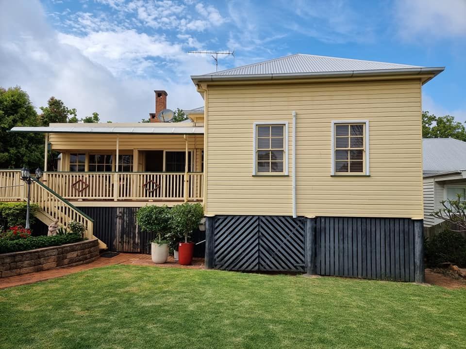 A Yellow House Is Being Restored — LMS Painting & Maintenance Pty Ltd In North Lambton, NSW