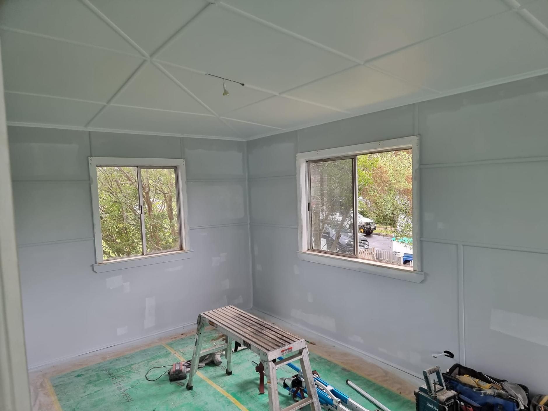 A Room With Two Windows And A Table In It — LMS Painting & Maintenance Pty Ltd In Charlestown, NSW
