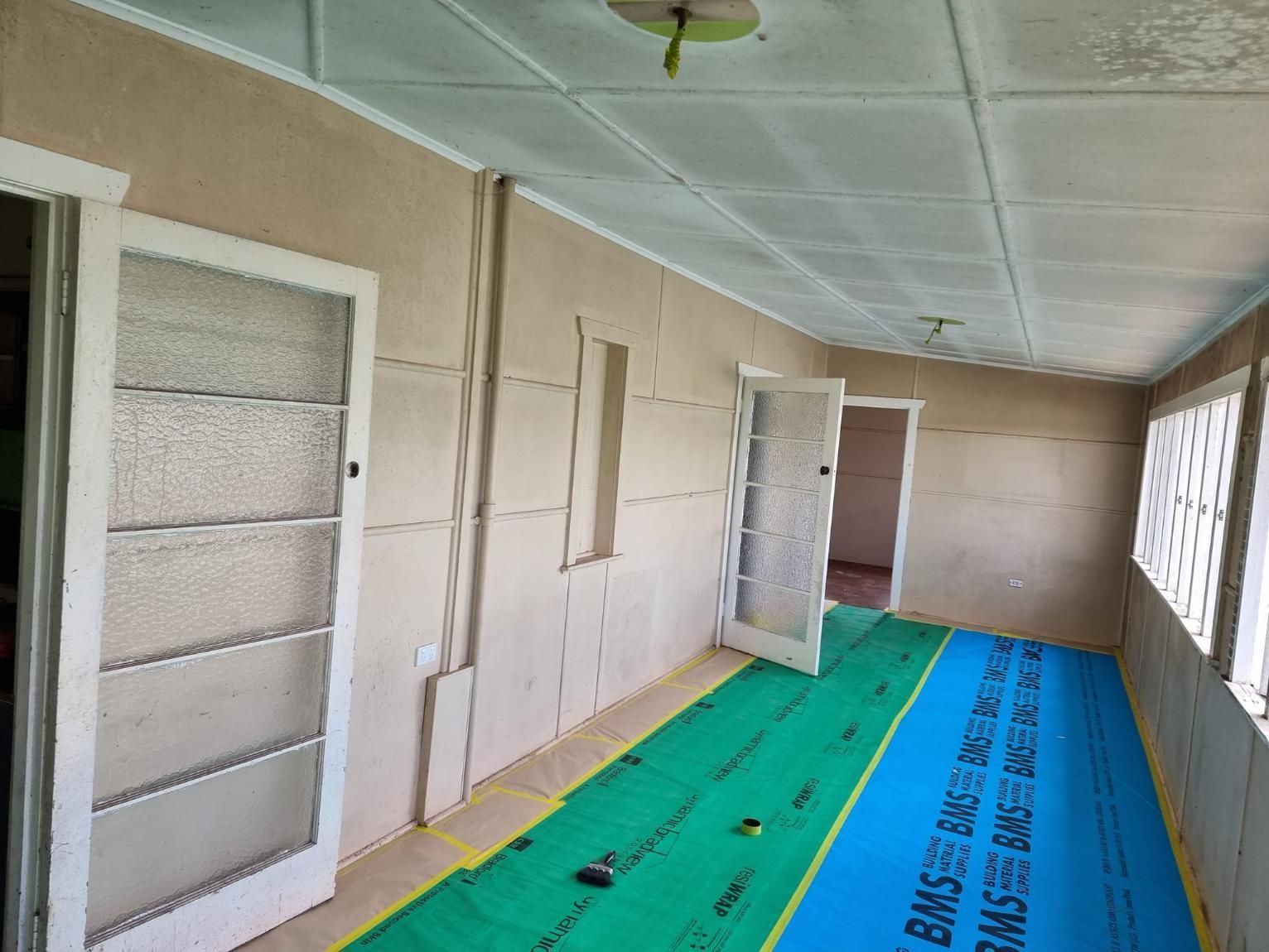 A Room With A Green Mat On The Floor And A Ceiling — LMS Painting & Maintenance Pty Ltd In North Lambton, NSW