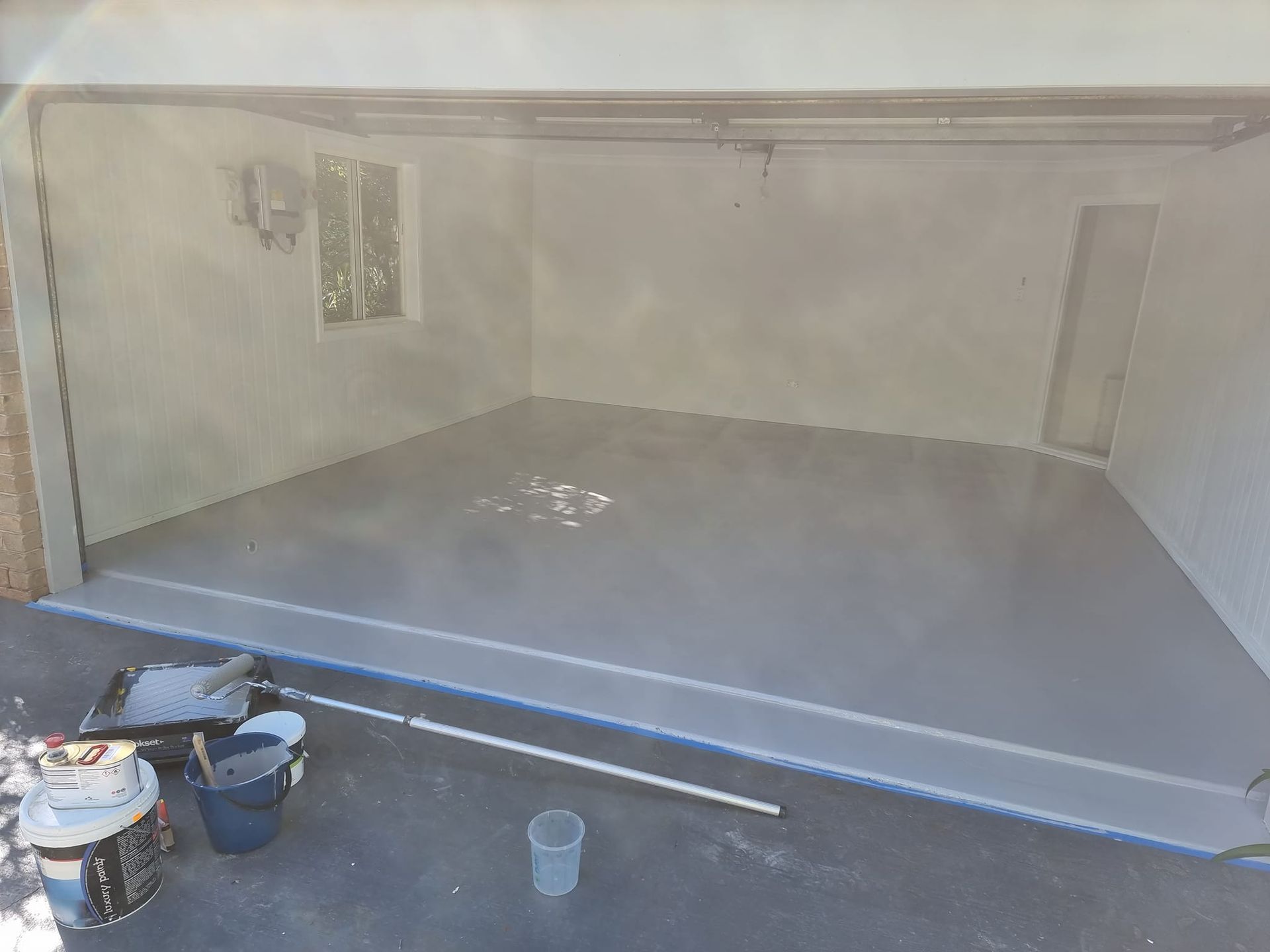 A Garage Is Being Painted In A Gray Color — LMS Painting & Maintenance Pty Ltd In North Lambton, NSW