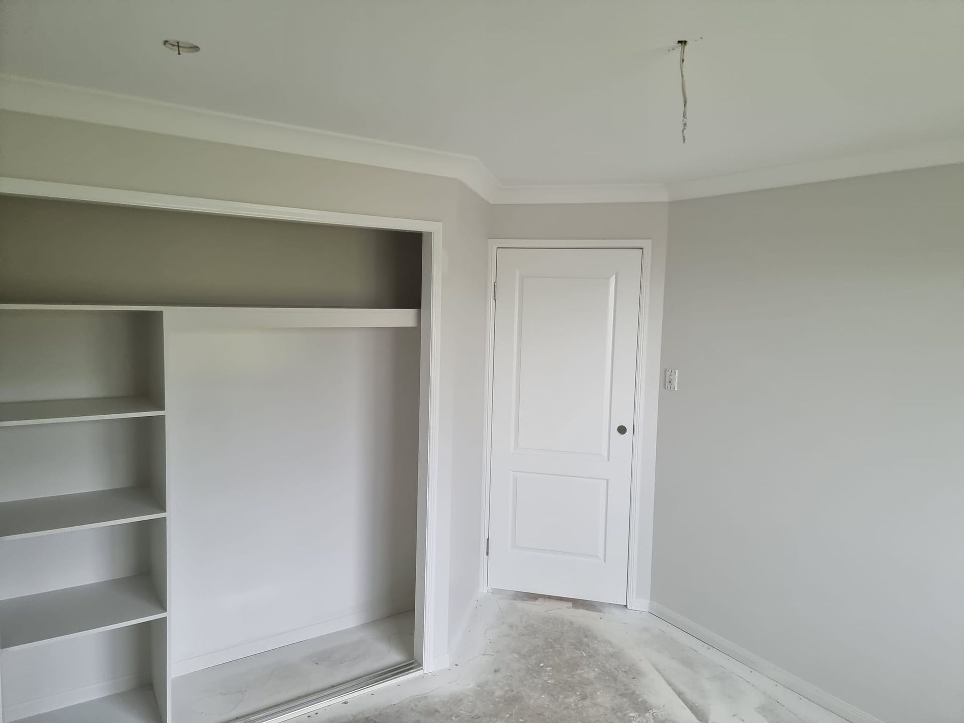 An Empty Room With A Closet And A Door — LMS Painting & Maintenance Pty Ltd In Lake Macquarie, NSW