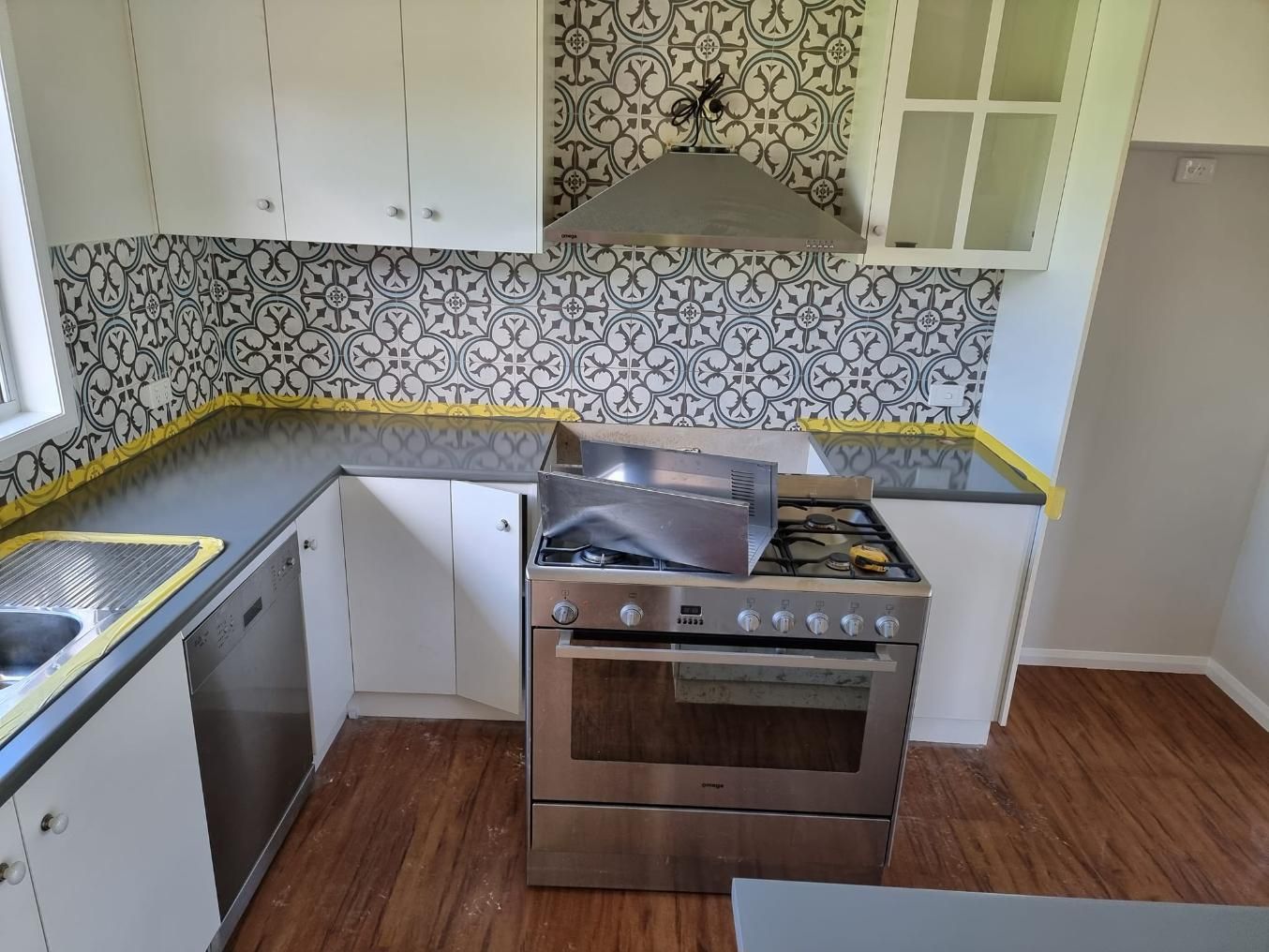 A Kitchen With Stainless Steel Appliances And Granite Counter Tops — LMS Painting & Maintenance Pty Ltd In Thornton, NSW