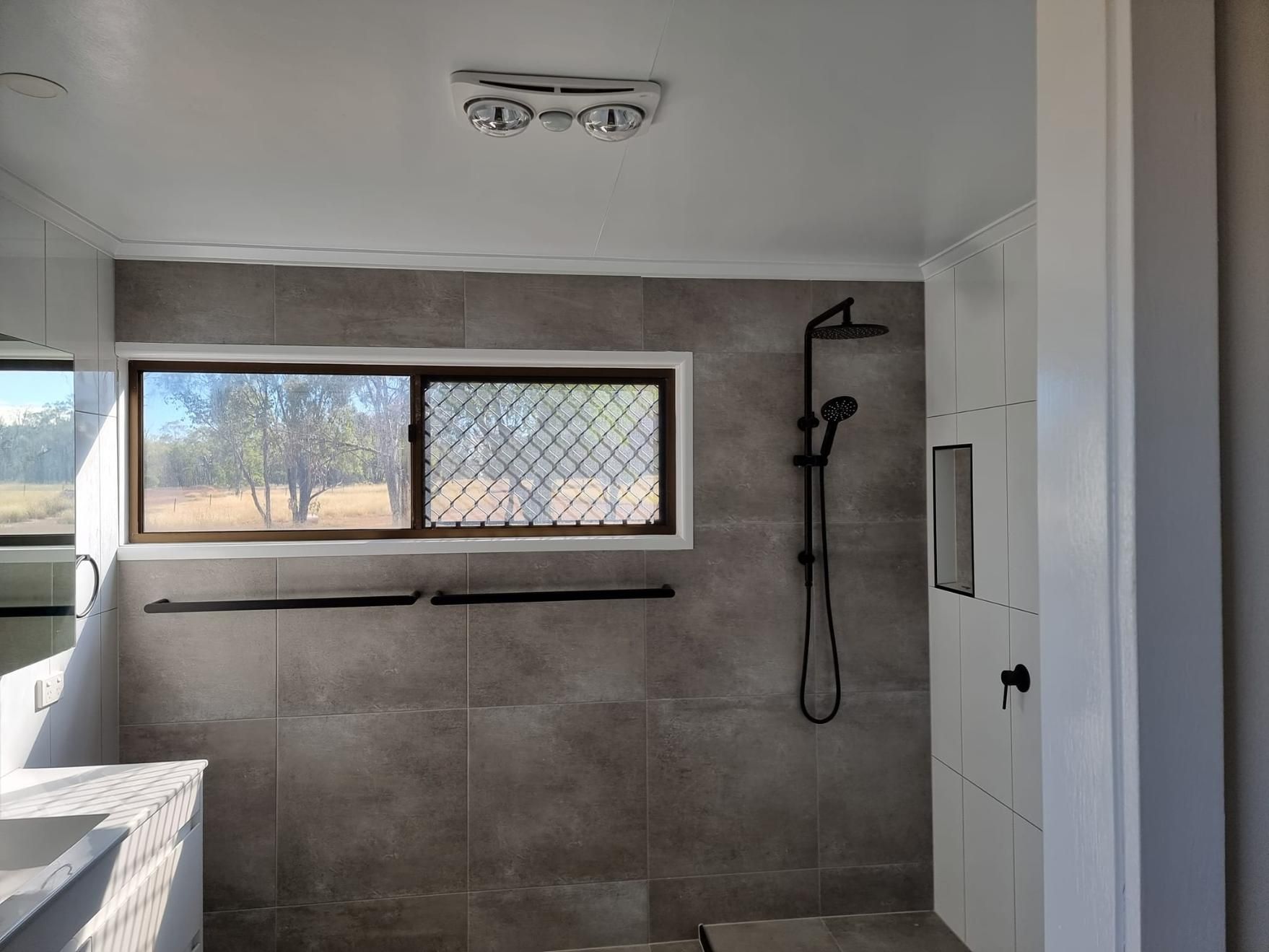 A Bathroom With A Walk In Shower And A Window — LMS Painting & Maintenance Pty Ltd In Medowie, NSW
