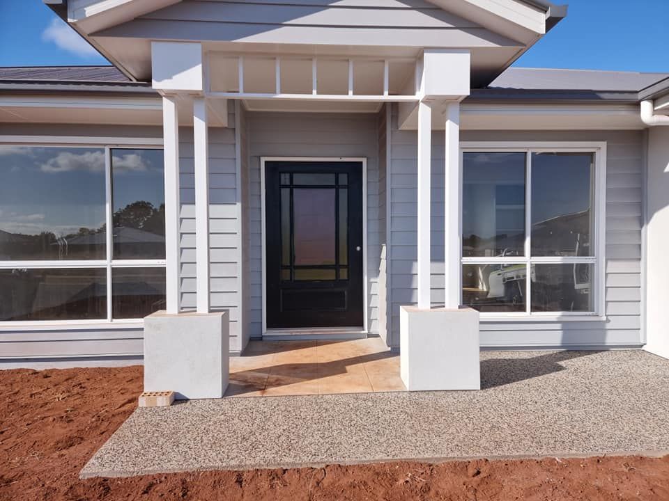 The Front Of A House With A Black Door And Windows — LMS Painting & Maintenance Pty Ltd In North Lambton, NSW
