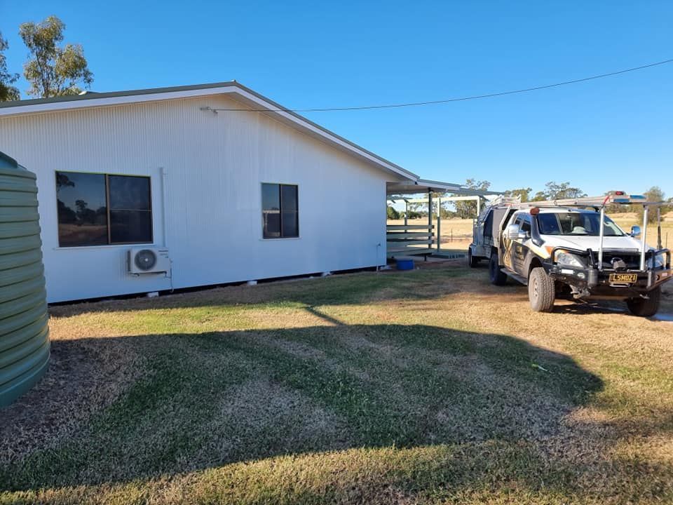 A White House With A Truck Parked In Front Of It — LMS Painting & Maintenance Pty Ltd In Singleton, NSW