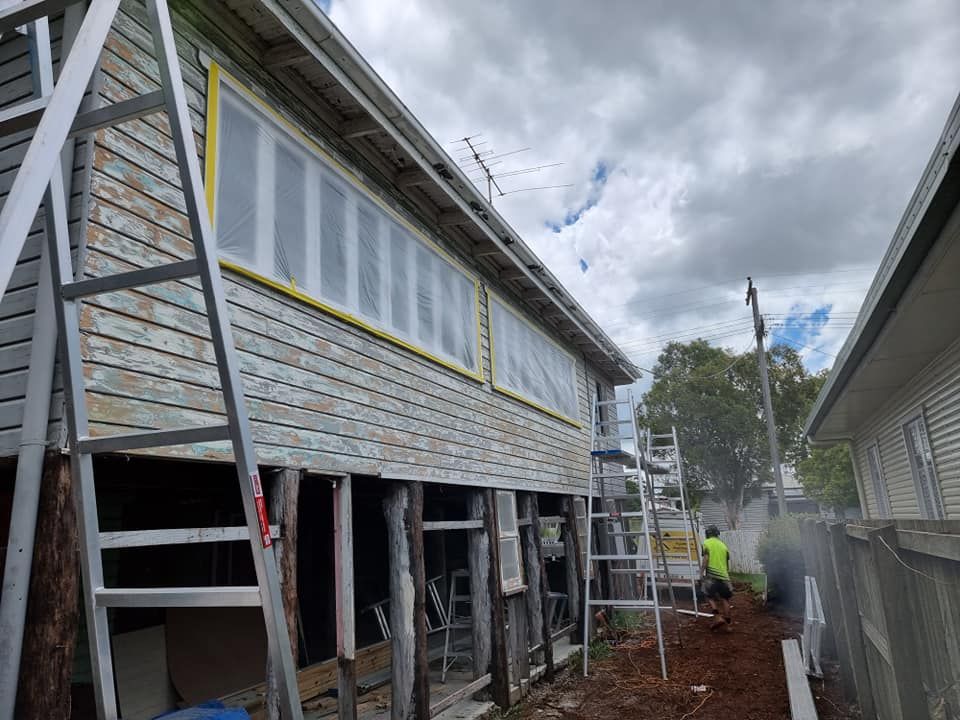 A House Is Being Remodeled With A Ladder On The Side Of It — LMS Painting & Maintenance Pty Ltd In North Lambton, NSW