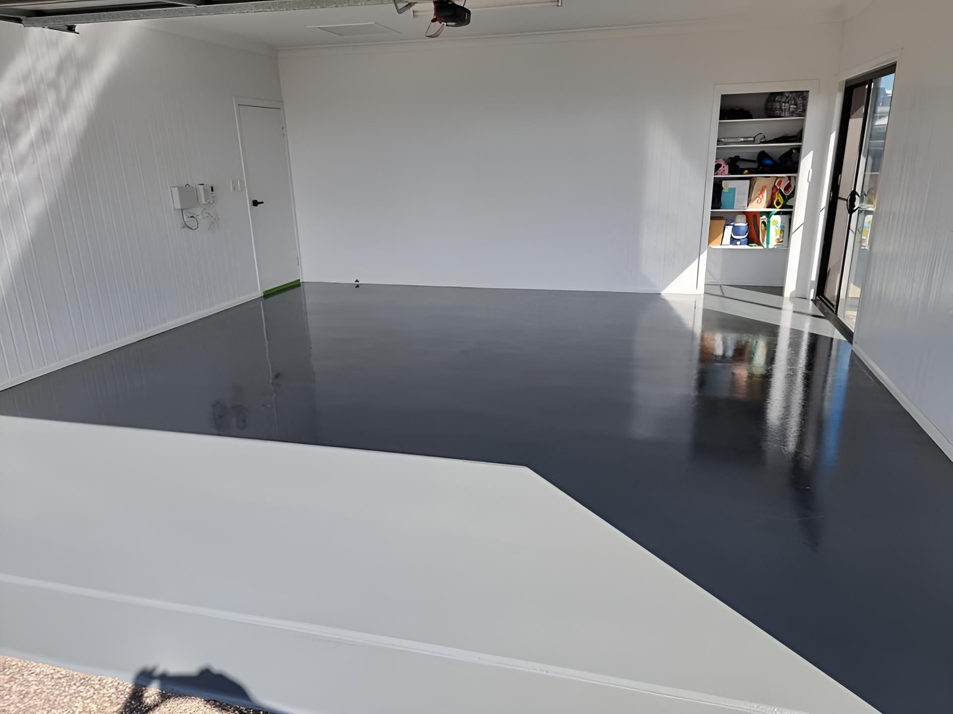 A Large Room With A Black Floor And White Walls — LMS Painting & Maintenance Pty Ltd In North Lambton, NSW