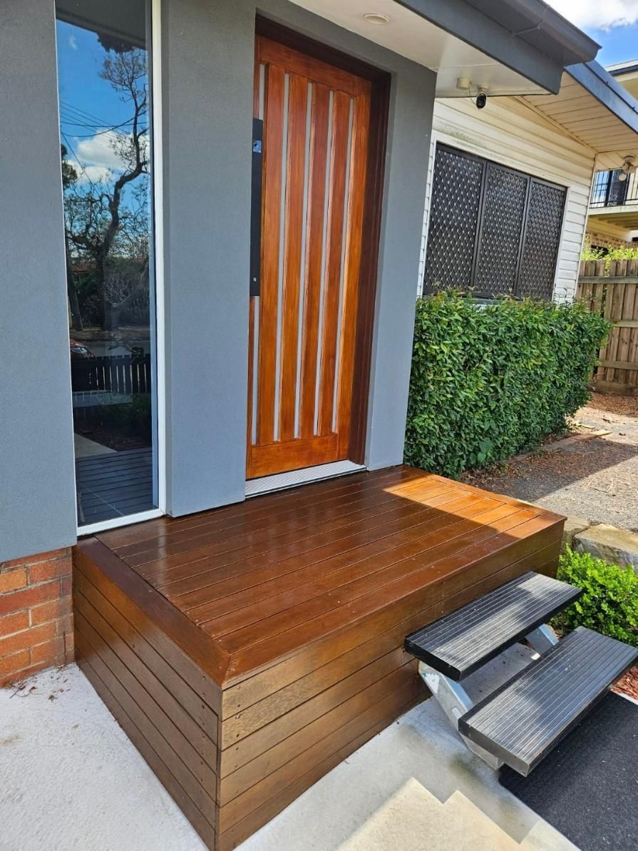 A Wooden Porch With Stairs Leading To The Front Door Of A House — LMS Painting & Maintenance Pty Ltd In Newcastle, NSW
