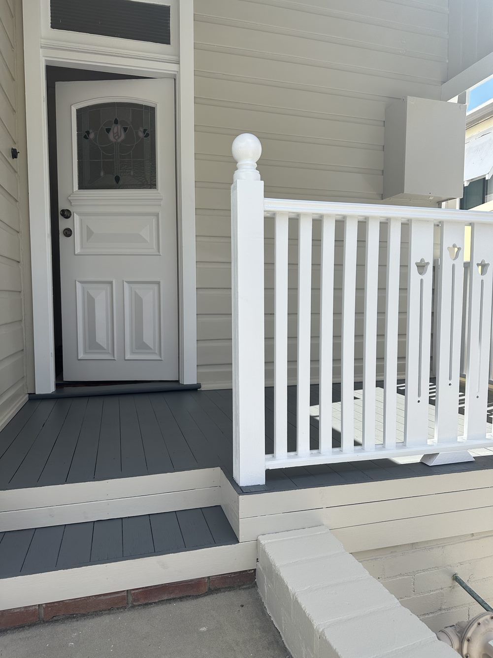 A white porch with a white railing and a white door — LMS Painting & Maintenance Pty Ltd In North Lambton, NSW