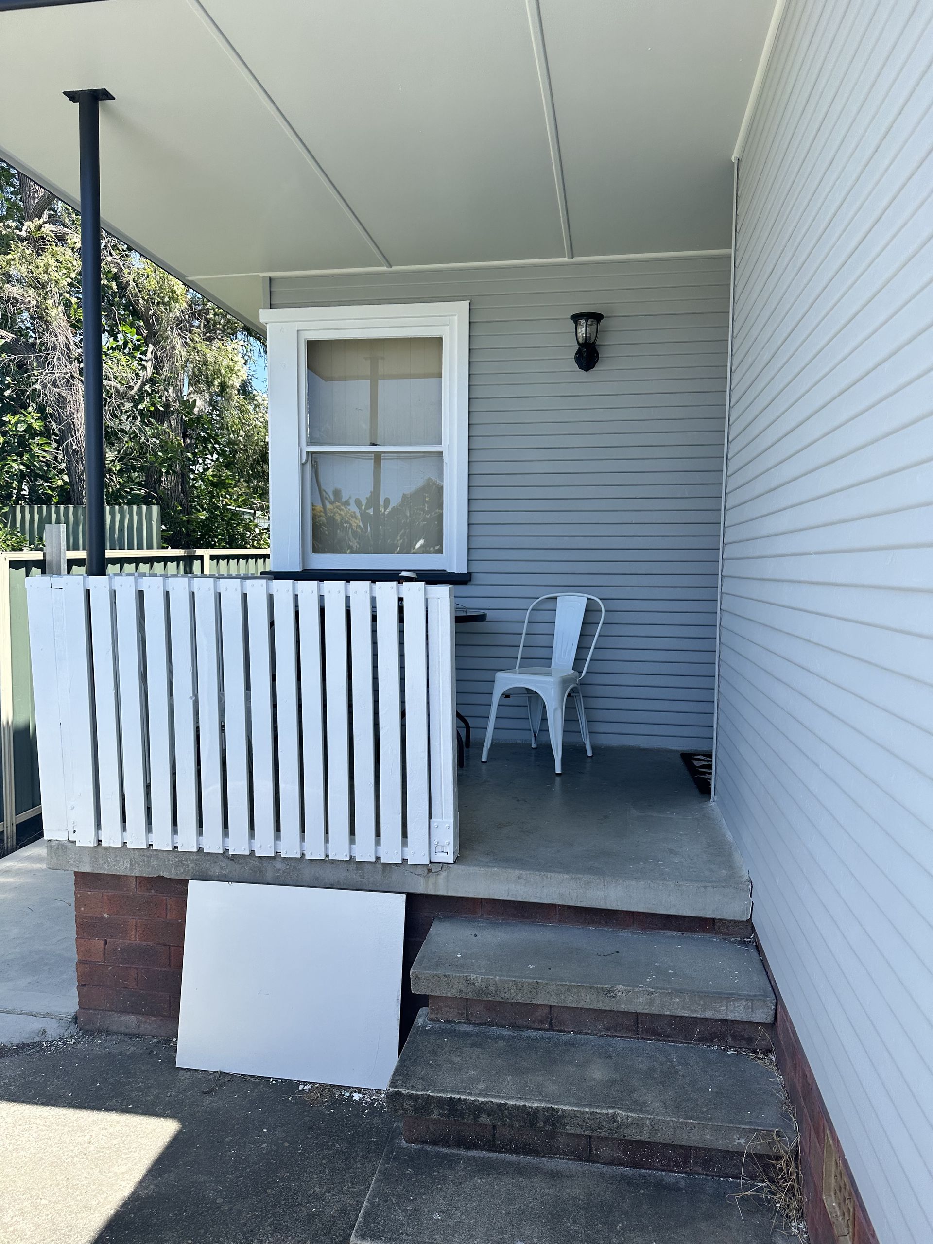 A white house with a porch and chairs on it — LMS Painting & Maintenance Pty Ltd In North Lambton, NSW