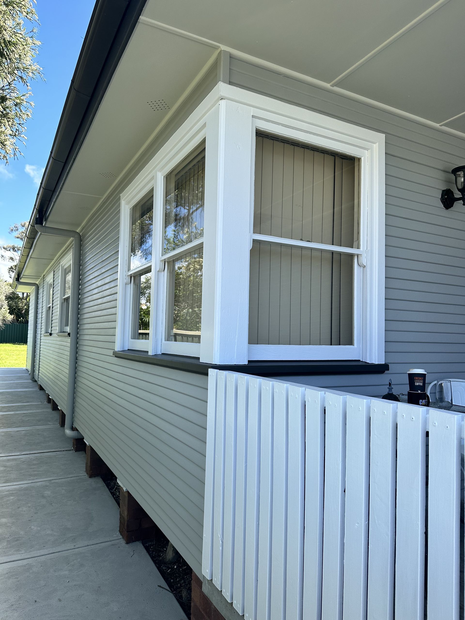 A house with a white fence and a lot of windows — LMS Painting & Maintenance Pty Ltd In North Lambton, NSW