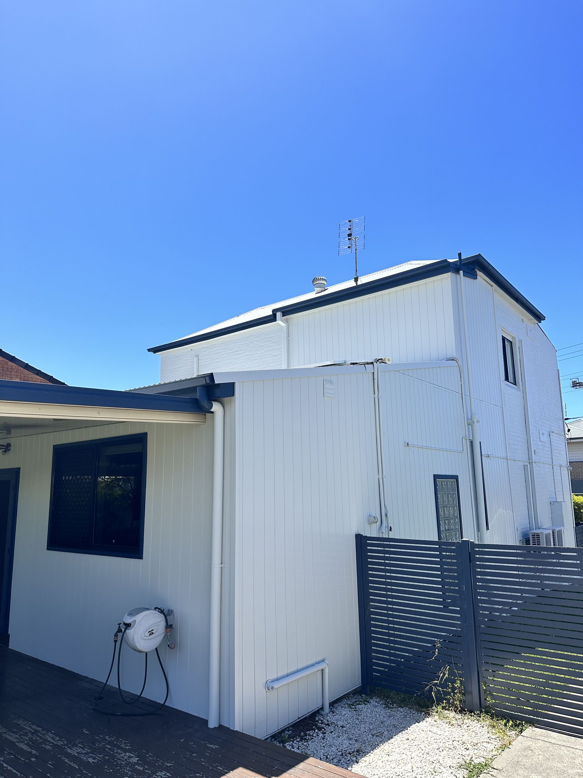 A white house with a blue sky in the background — LMS Painting & Maintenance Pty Ltd In North Lambton, NSW