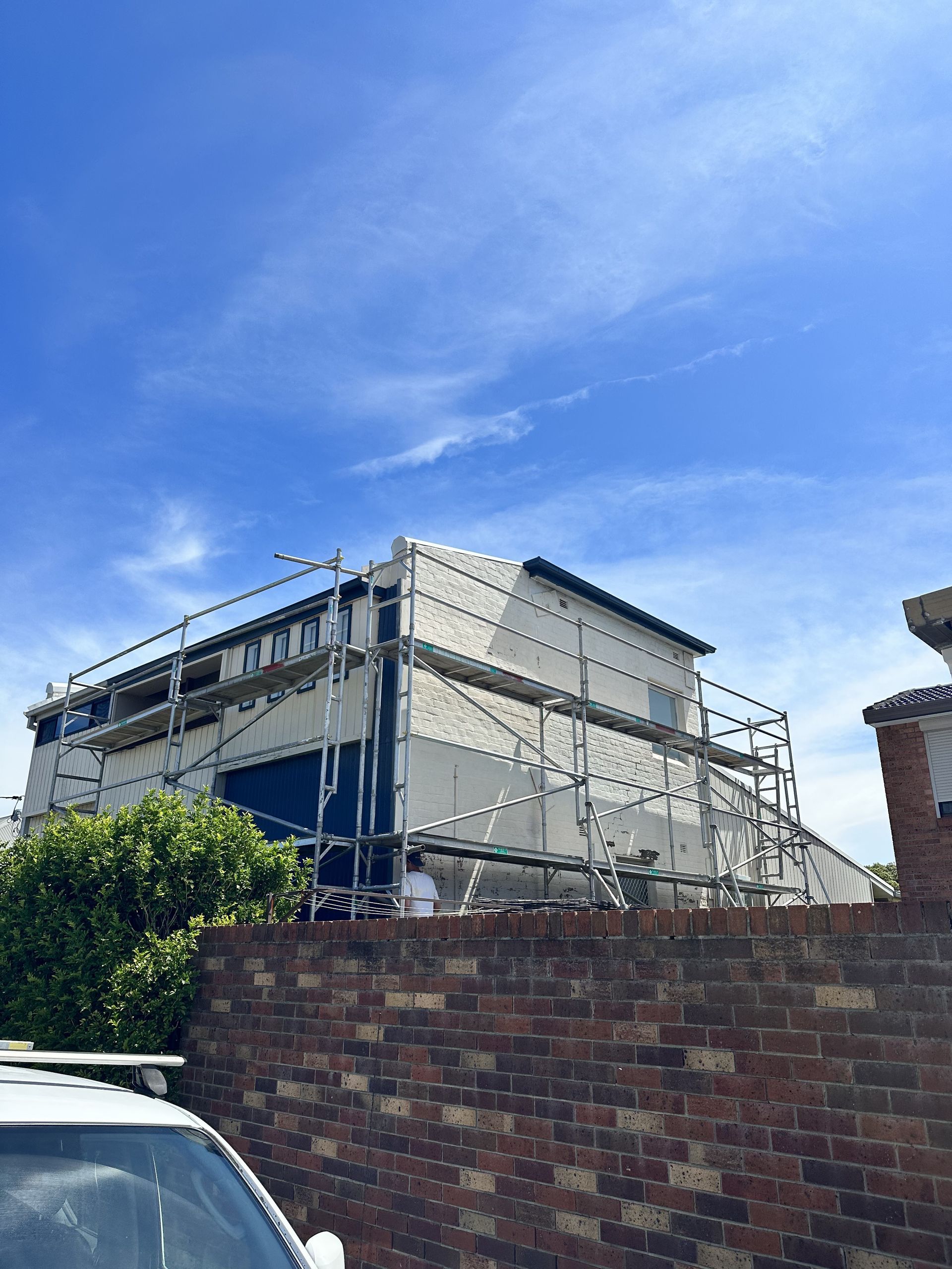 A car is parked in front of a building under construction  — LMS Painting & Maintenance Pty Ltd In North Lambton, NSW