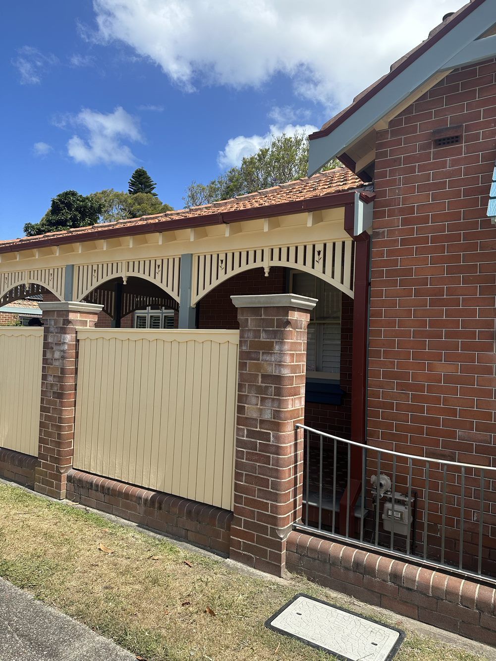 A brick building with a white fence around it — LMS Painting & Maintenance Pty Ltd In North Lambton, NSW