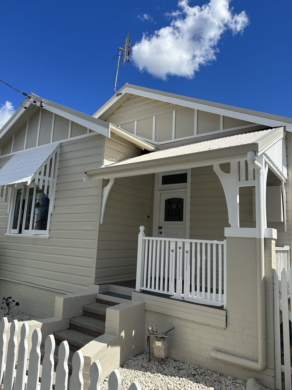 A white house with a porch and a white fence — LMS Painting & Maintenance Pty Ltd In North Lambton, NSW