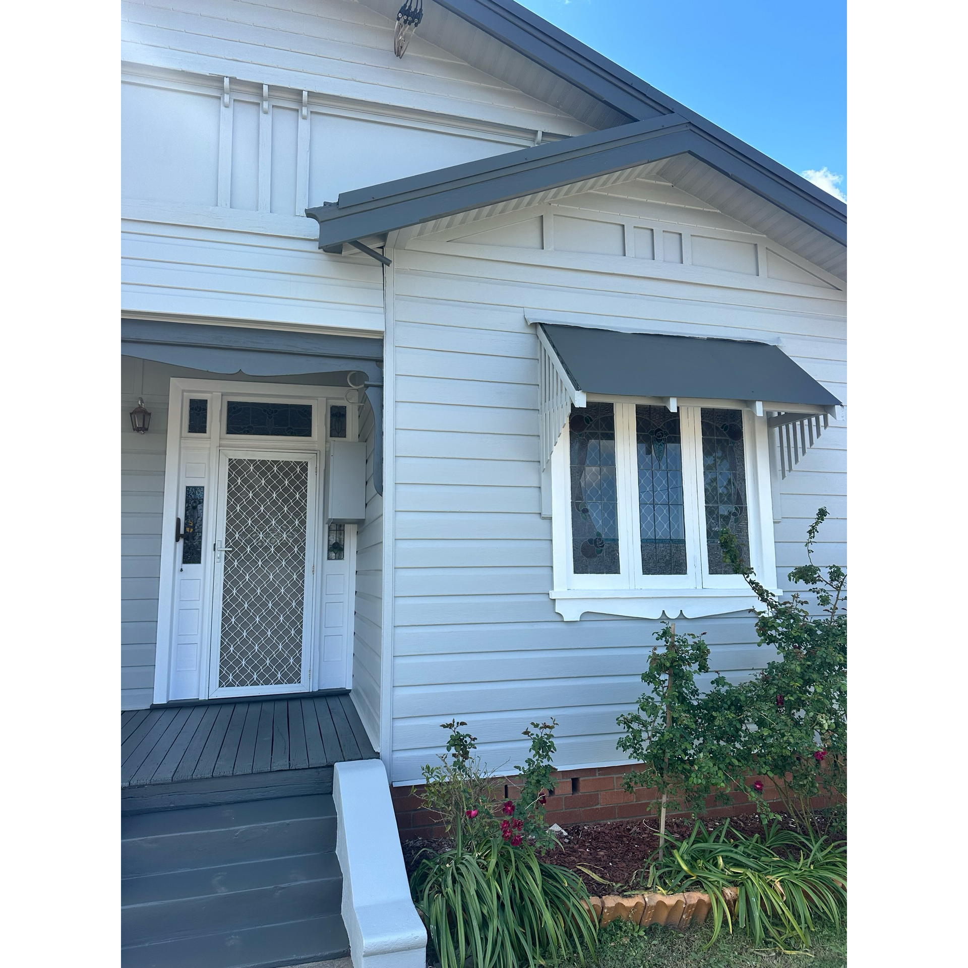 The front of a white house with a gray roof — LMS Painting & Maintenance Pty Ltd In North Lambton, NSW
