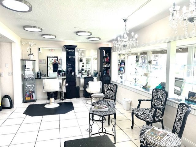 A salon with a lot of chairs and tables