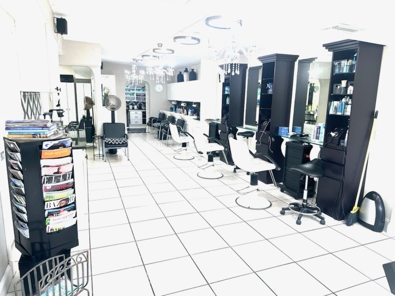 A hair salon with lots of chairs and shelves