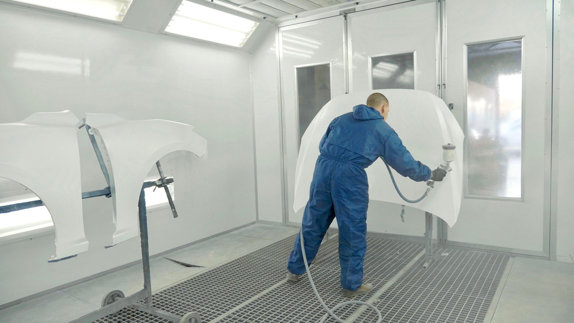 Painter Spraying White Paint on Car — Geelong, VIC — Geelong Accident Repair
