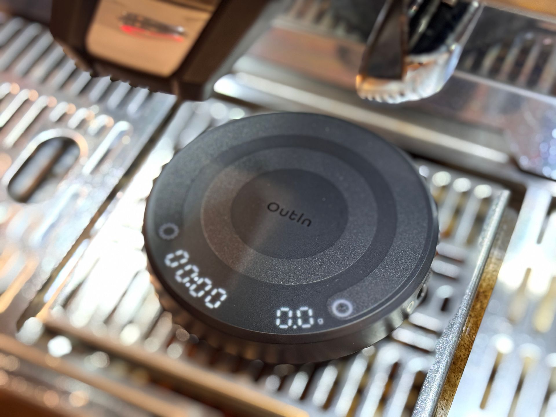 Black circular puck-style gadget labeled “Oculus” on a metallic surface with controls and grill slots